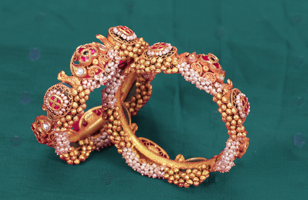 Gold bangles with pearl detailing